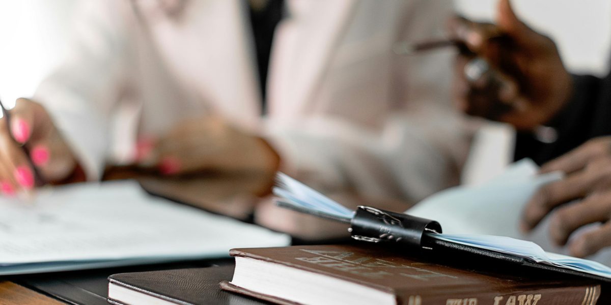 Professionals meticulously reviewing documents, emphasizing legal and compliance considerations.