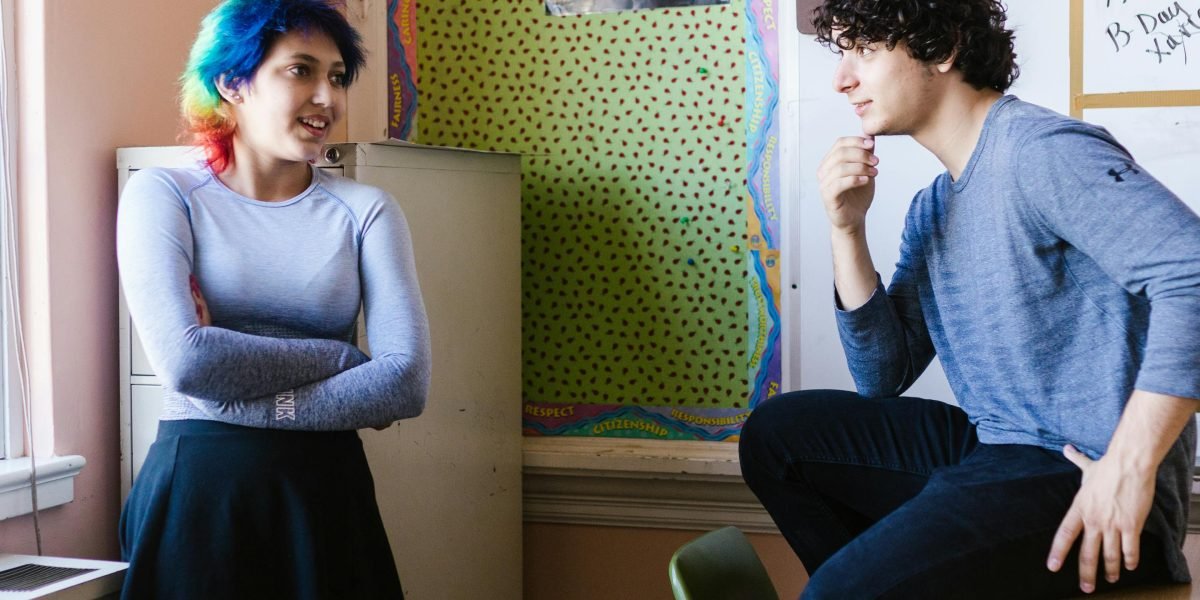 An educator engaging in a constructive conversation with a student, representing a balanced approach to academic integrity beyond just tool scores.