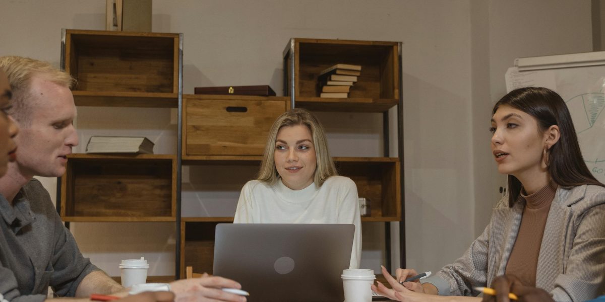 A group of diverse professionals collaboratively discussing a strategic plan in a modern office setting.