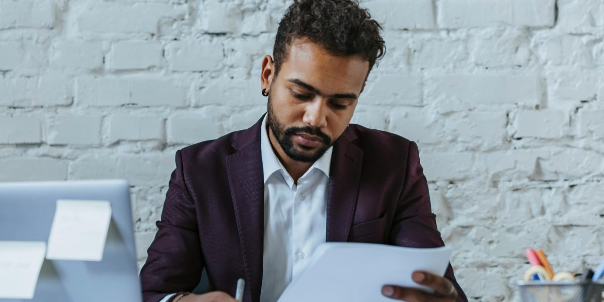 A person carefully reviewing documents, symbolizing the meticulous process of AI content detection.