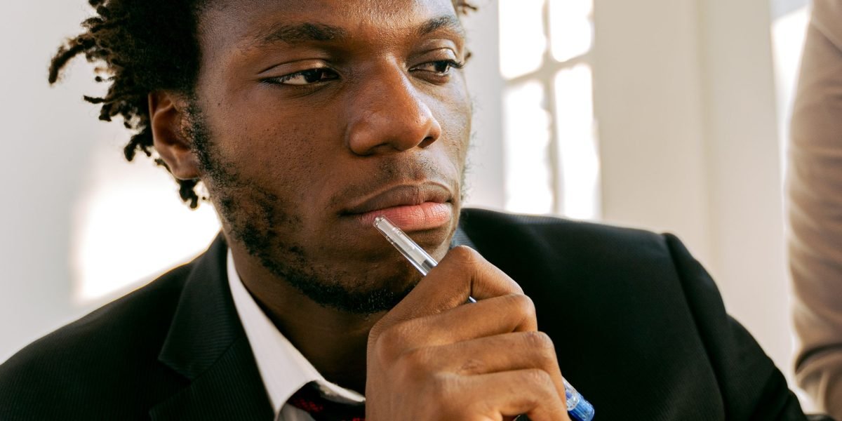 A creative professional contemplating ideas, symbolizing the conceptualization phase of a project.