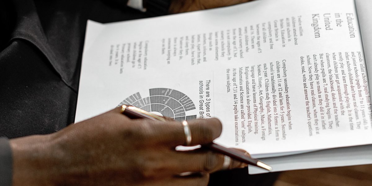 A person carefully reviewing documents, representing the need for verification and attention to detail in AI-generated content.