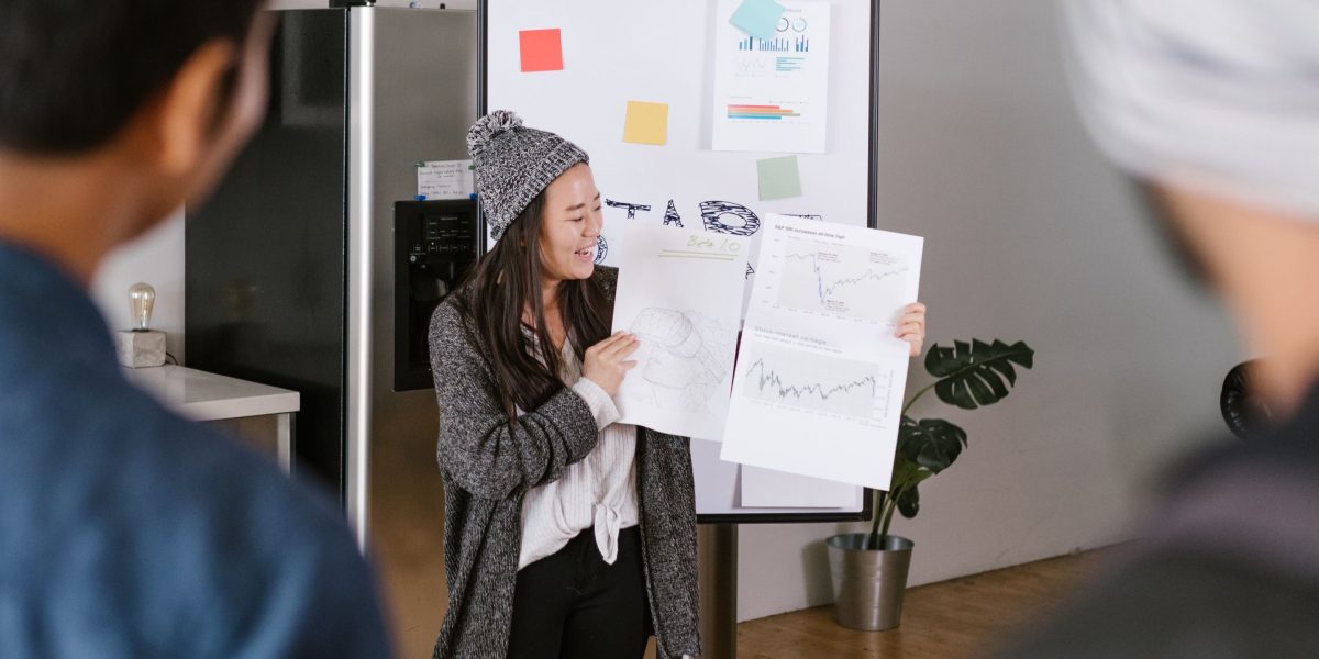 A person presenting ideas to a group, envisioning real-time collaboration and pitching in future creative workflows.