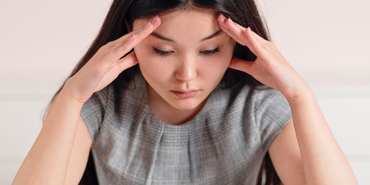 A person expressing a sense of confusion or being overwhelmed, symbolizing information vertigo in the digital age.