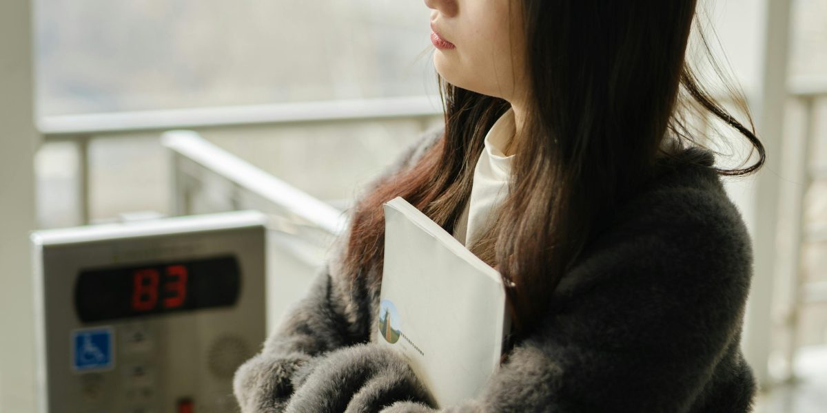 A person contemplating the authenticity of documents, highlighting the need for AI detection tools.