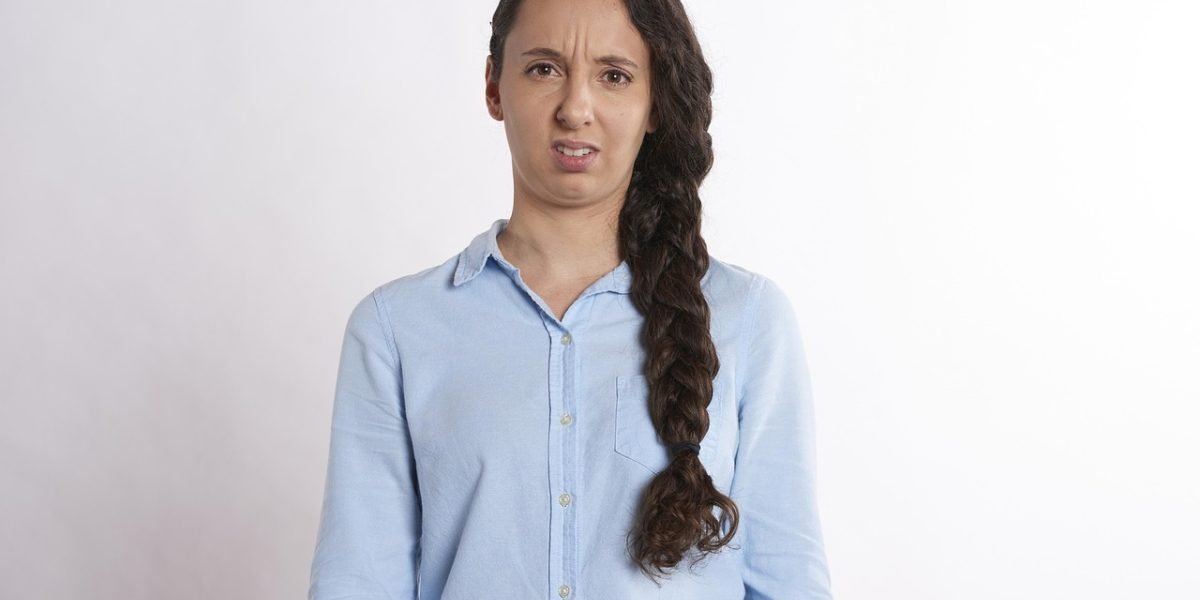 A person looking worried while reviewing legal documents, illustrating the potential legal and compliance risks associated with imperfect AI detection.