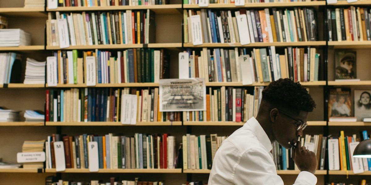 A student deeply engrossed in research, highlighting the focus required for academic work.