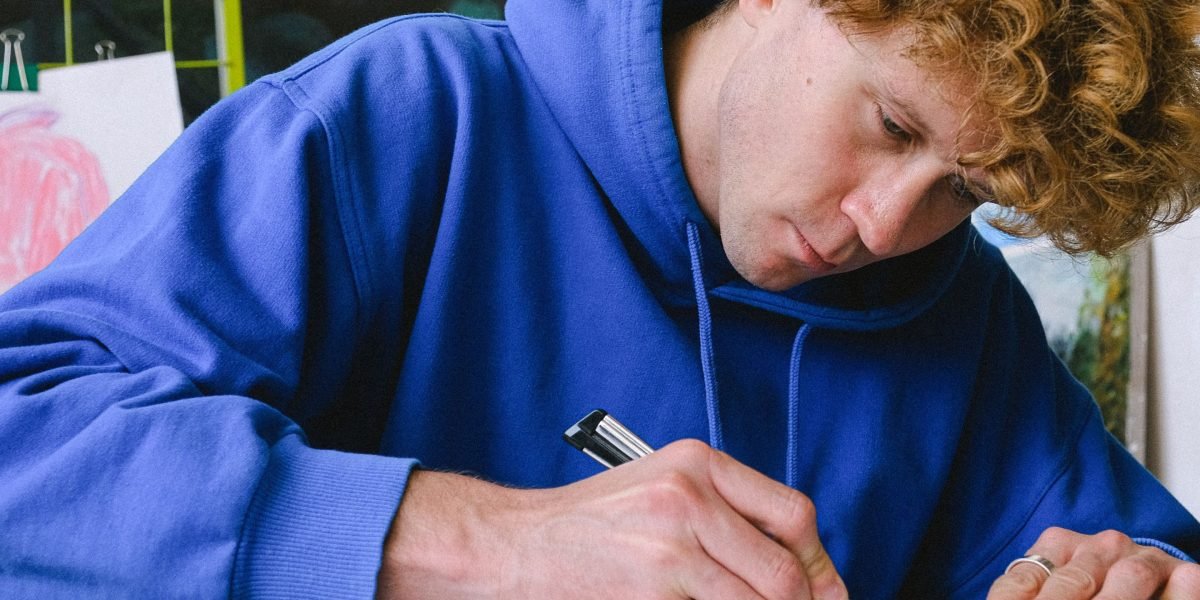 An individual focused on creating a project, emphasizing human effort and authenticity.