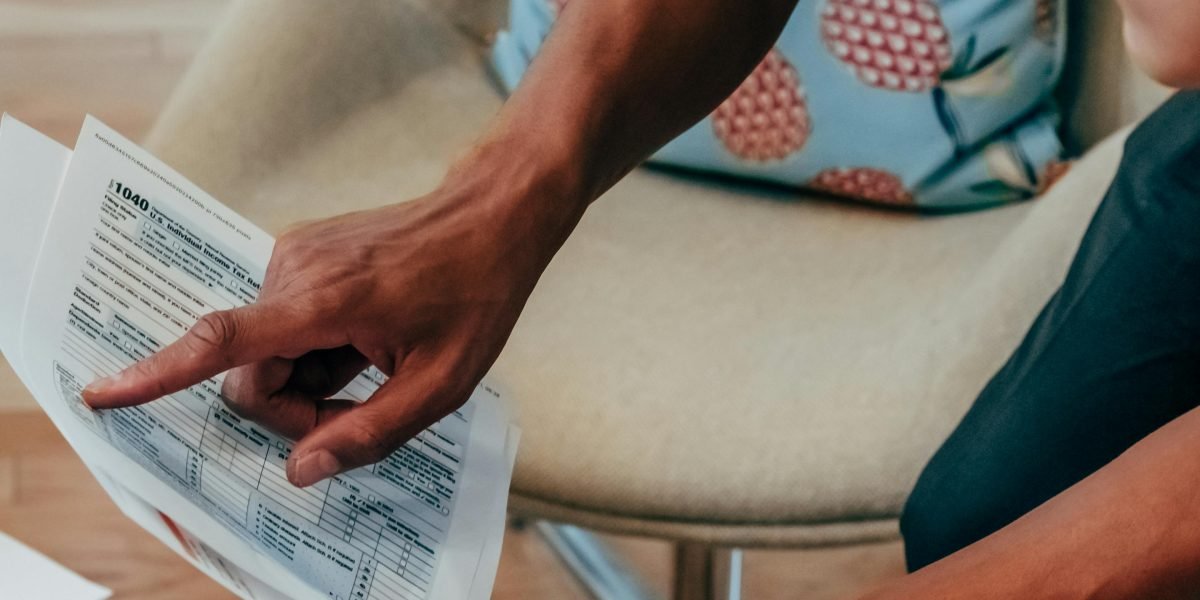 A person thoughtfully reviewing documents, emphasizing the need for critical evaluation in the age of AI-generated content.