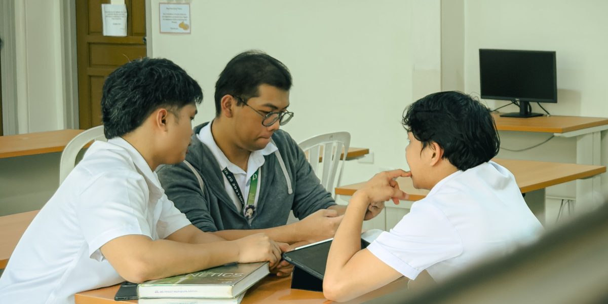 An educator and student discuss a project, highlighting the importance of original work in academic settings.