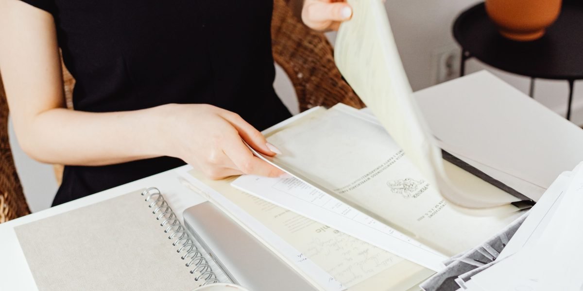 A person intently reviewing documents, reflecting the need for trustworthy and authentic content.