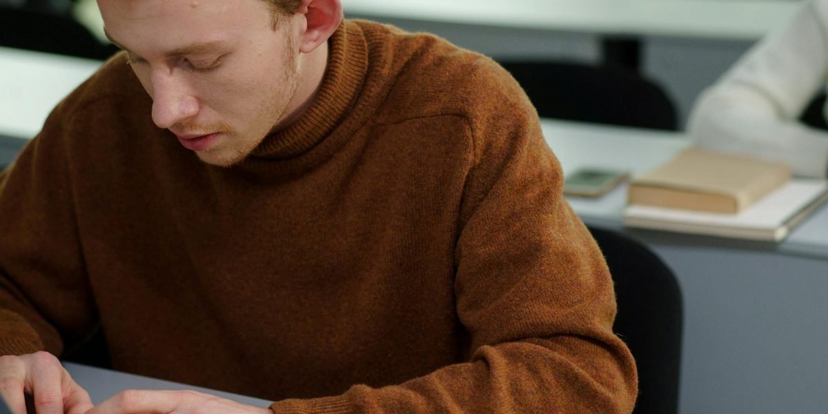A student deeply focused on their schoolwork, emphasizing academic integrity in the age of AI.