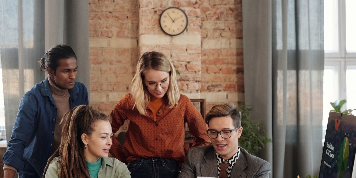 A marketing team collaborating in an office setting, ensuring their content is authentic and resonates with readers.