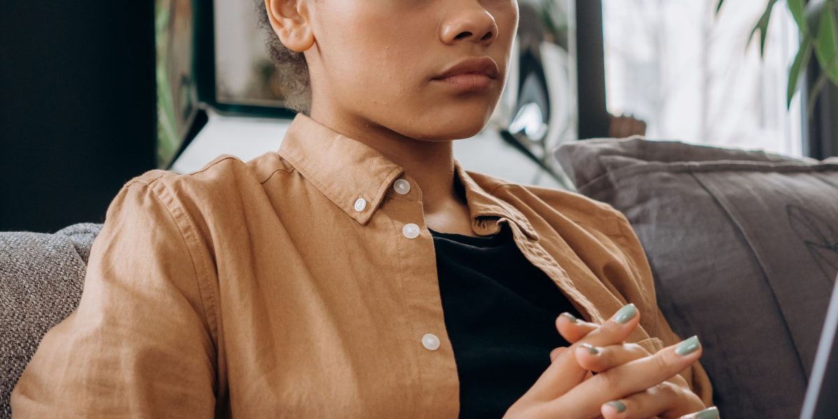A person looking thoughtfully at a screen, pondering the authenticity of an online interaction.