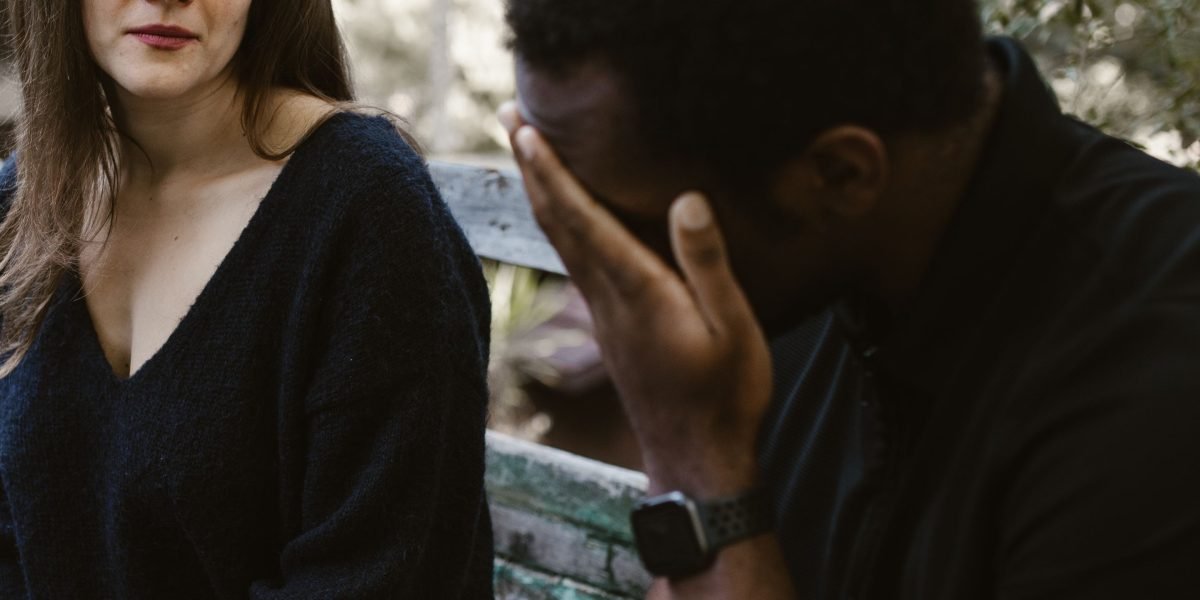 A person exhibiting a slight unease or anxiety while looking at a digital interface, reflecting the discomfort of automation anxiety.