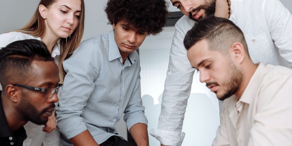 A group of people collaborating effectively in a modern setting, symbolizing successful human-AI partnership.