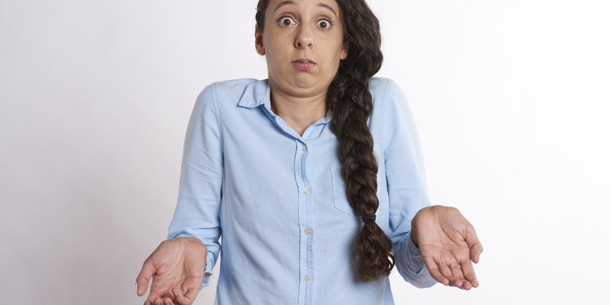 A person expresses confusion or uncertainty while reviewing documents, reflecting the challenges of discerning truth from AI-generated content.