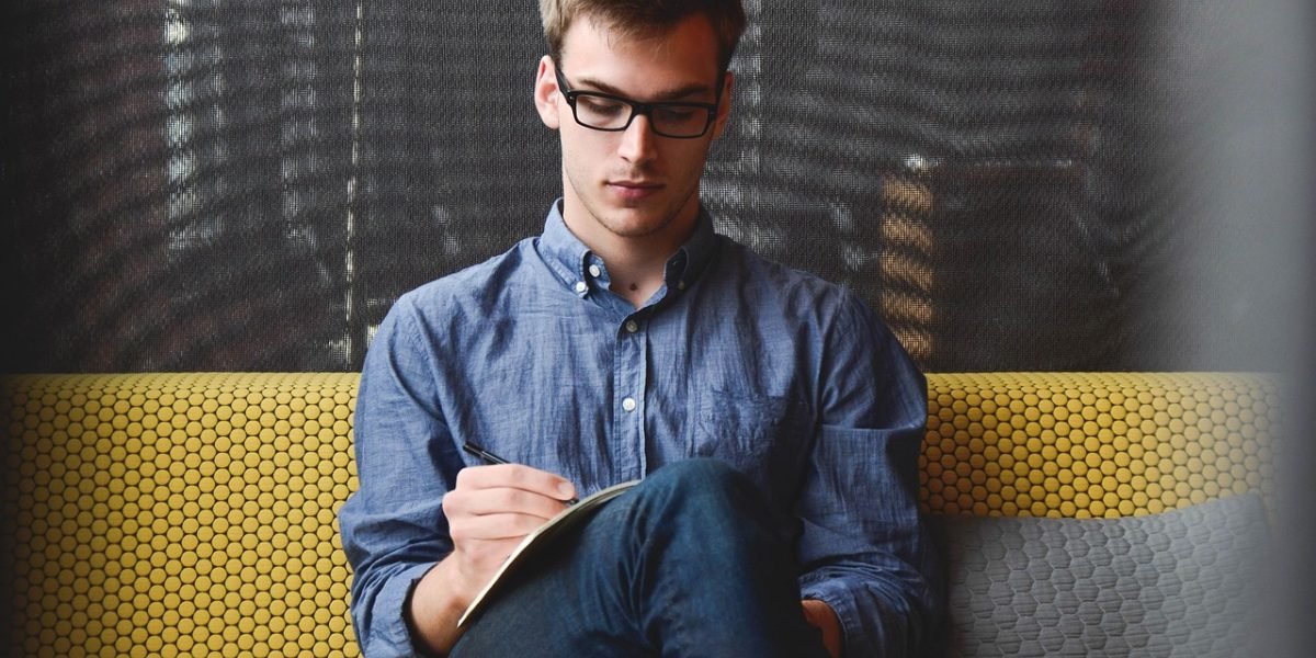 An individual focused on writing extensive content, illustrating the application for long-form AI detection tools.