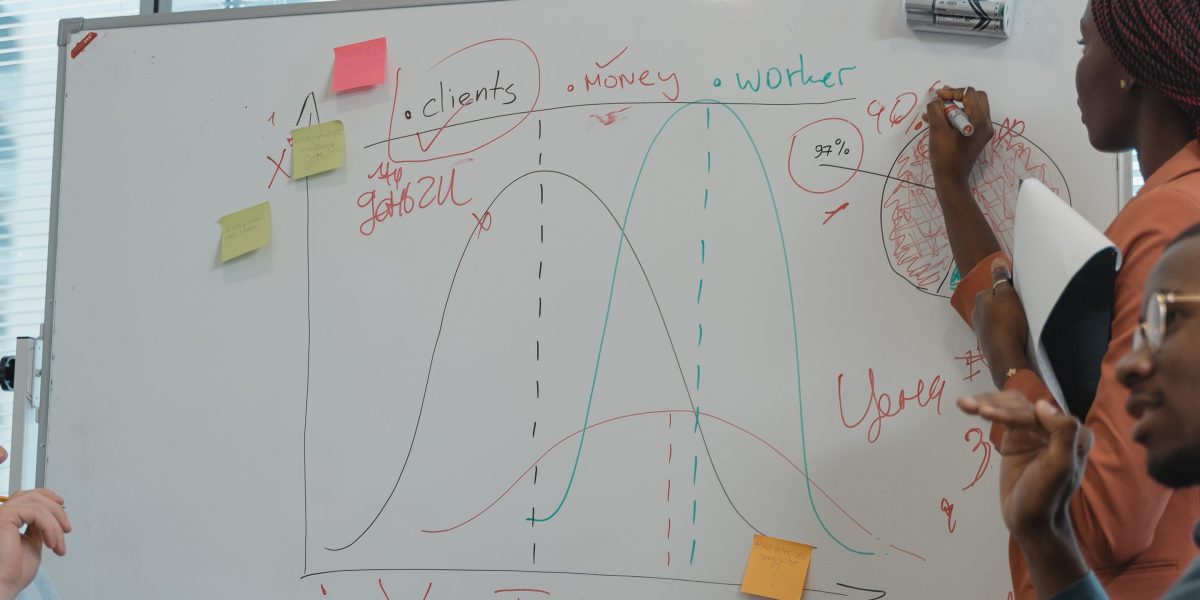 A group of marketers discussing strategy in a meeting, representing the financial risks associated with AI content in SEO.