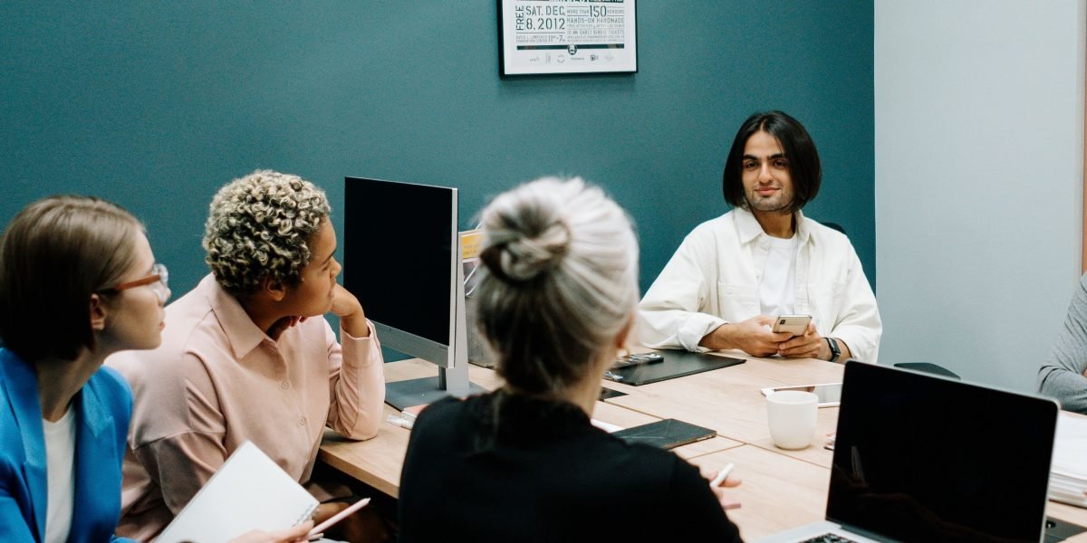 A group of professionals discussing content authenticity and building trust in the age of AI.